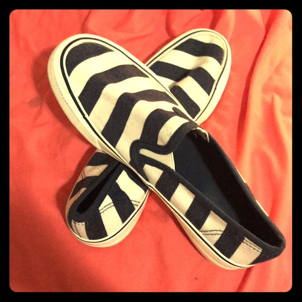 Navy blue and white striped slip-on shoes.